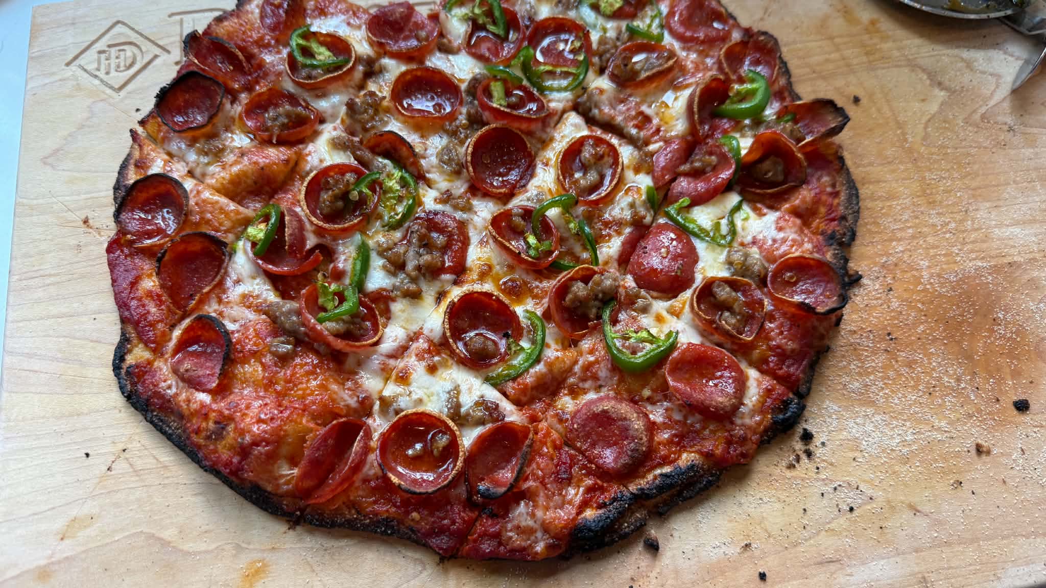 Square-cut pepperoni pizza on a wooden board